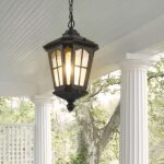 A black outdoor chandelier with a retro lantern effect can be seen hanging from the ceiling of a terrace.