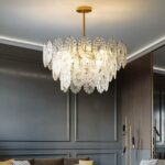 Bohemian crystal chandelier with ornate pendant in a grey living room with wood panelling