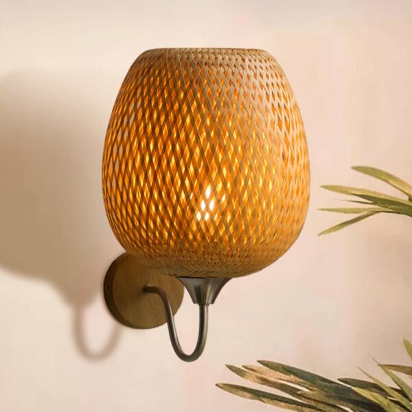 Bohemian wall lamp in rattan and bamboo presented wall-mounted and illuminated