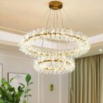 Bohemian LED chandelier in the shape of a wreath of flowers in a living room with a plant and a green curtain