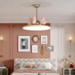 Chandelier for nursery with pink hearts, hanging over a bed