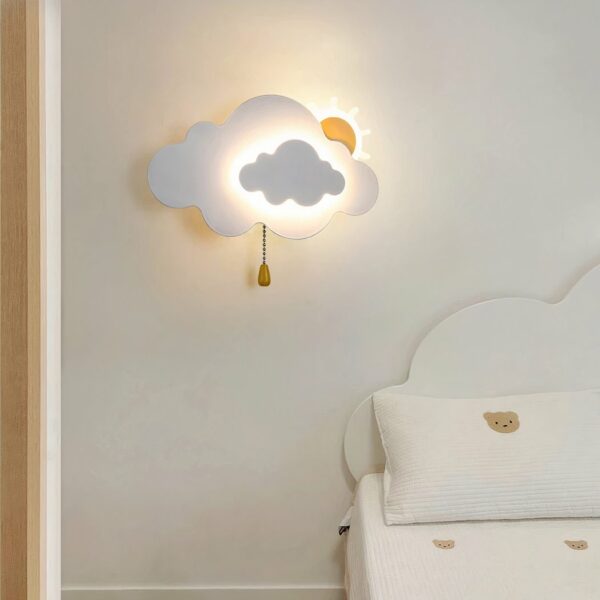 On the wall of a child's bedroom, a cloud-and-sun-shaped wall light is lit up and hung on the wall.