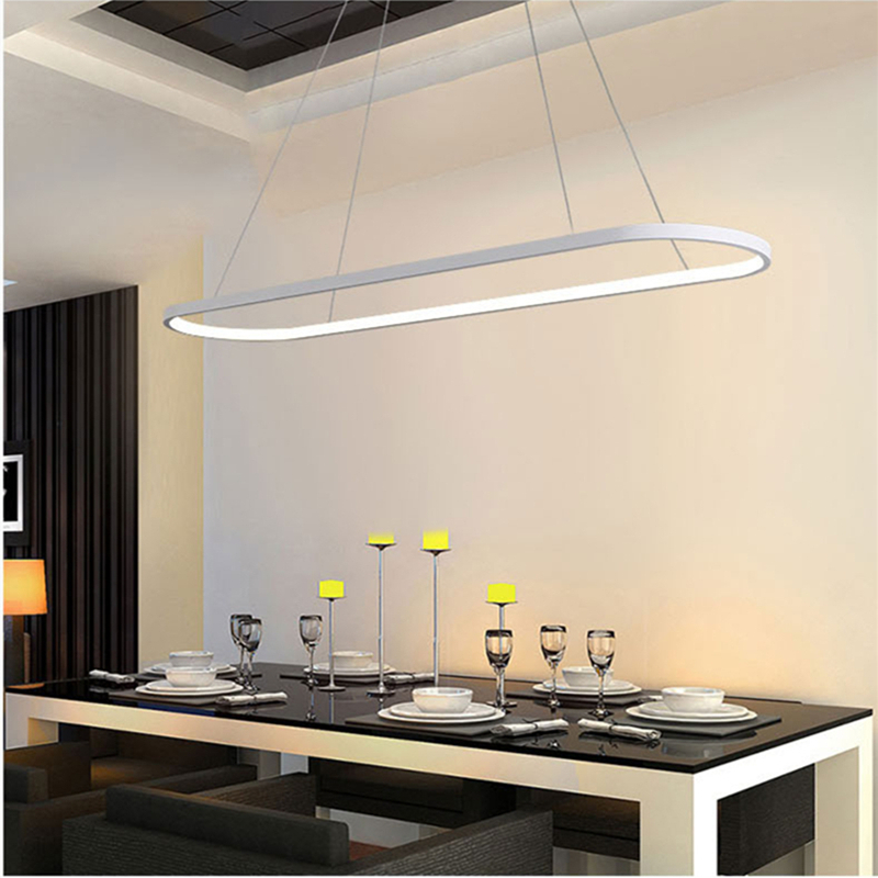 Contemporary oval LED pendant over a dining table