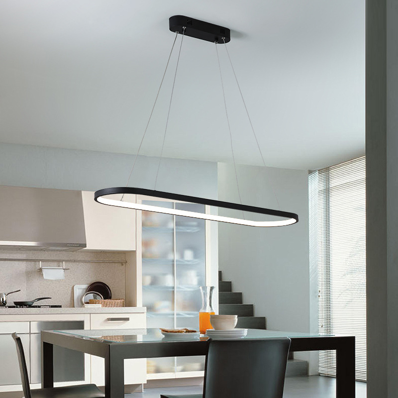 Contemporary oval LED pendant over a dining table