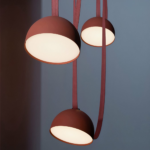 Creative terracotta three-headed pendant lamp in modern style on a grey background
