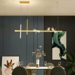 Decorative dragonfly hanging above a dining table in a designer setting