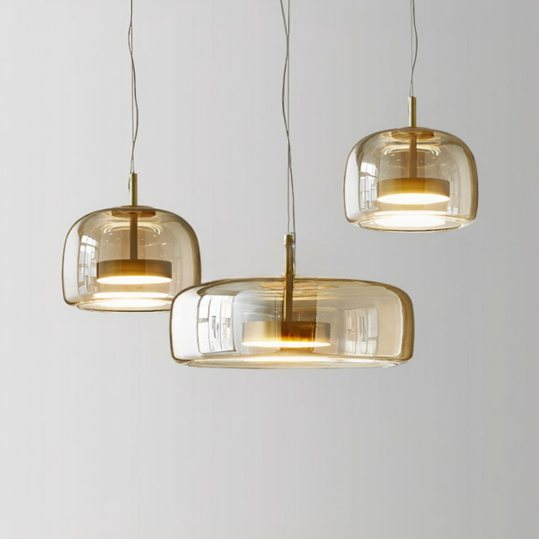 Three suspended glass fixtures, a large one in the center and two smaller ones on the sides, the one on the right is higher than the one on the left. On a gray background.