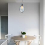 Blue Nordic glass teardrop pendant above a dining table