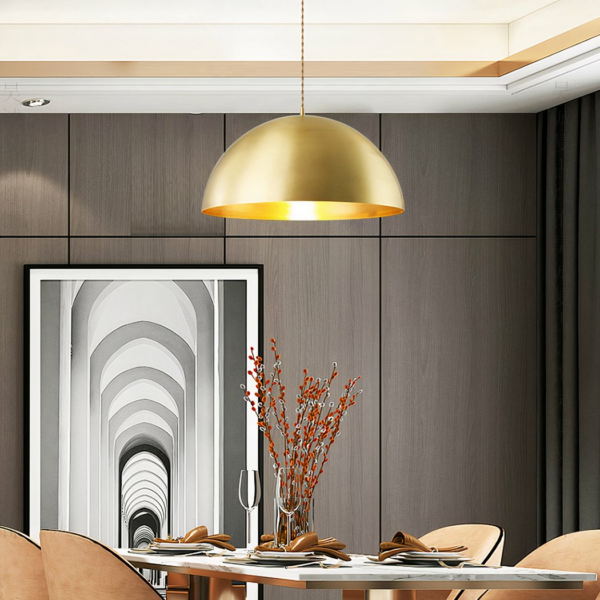 Vintage-style gold-plated brass LED hanging lamp on grey background with picture and table with chairs