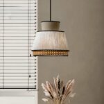 Vintage-style grey cane hanging lamp in fabric on a grey background with blinds on the left