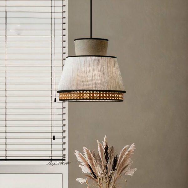 Vintage-style grey cane hanging lamp in fabric on a grey background with blinds on the left