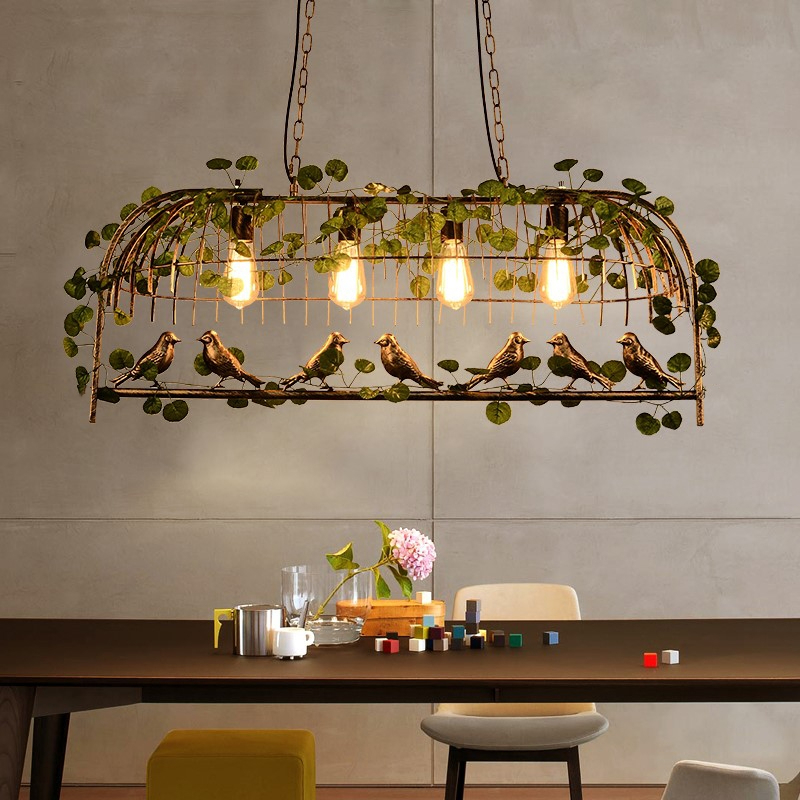 Suspension Bird open birdcage with foliage presented suspended above a bench