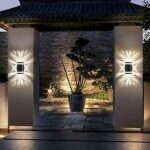 Large waterproof LED solar wall light on stone columns in a garden