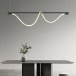 Black steel LED loft pendant above a dining table