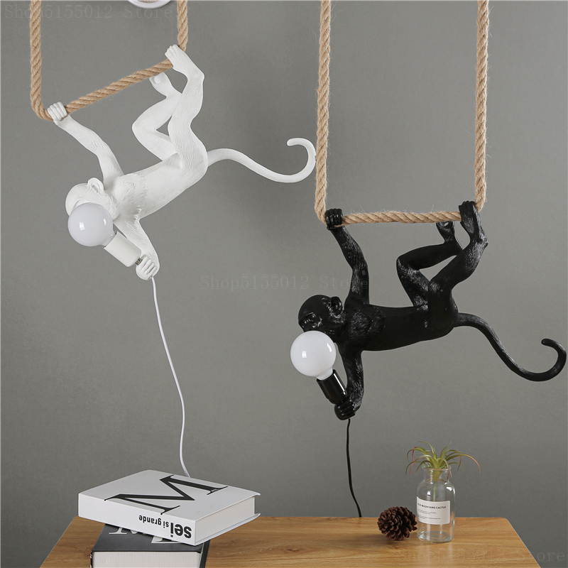 LED monkey hanging upside down from a lit rope