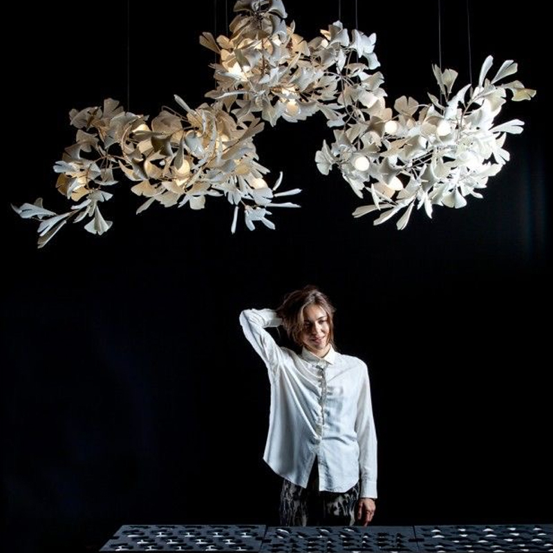 Slim, elegant white leaf suspension presented on a black background
