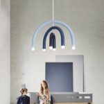 Minimalist rainbow LED children's chandelier in a minimalist bedroom with two children