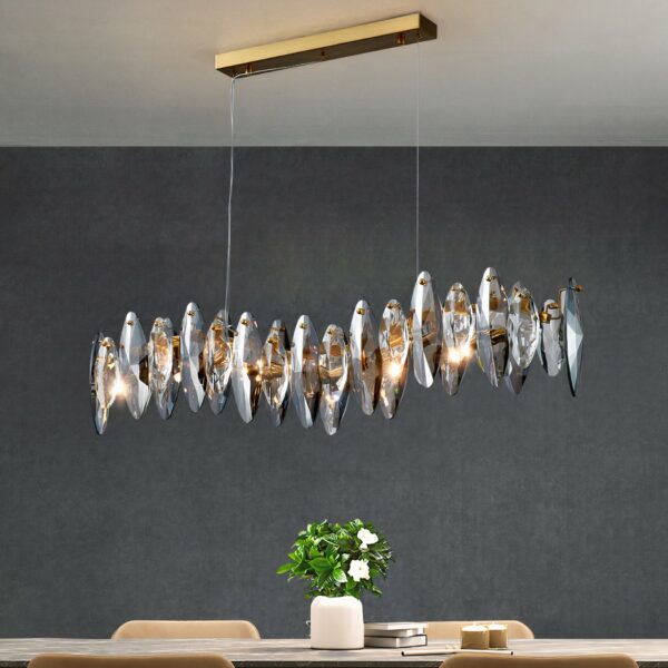 Modern dining room chandelier in crystal and stainless steel on grey background
