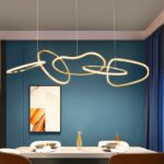 Modern dining room chandelier with luminous rings on a blue background with a table