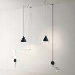 Minimalist modern pendant with decorative exposed wire presented on a white wall