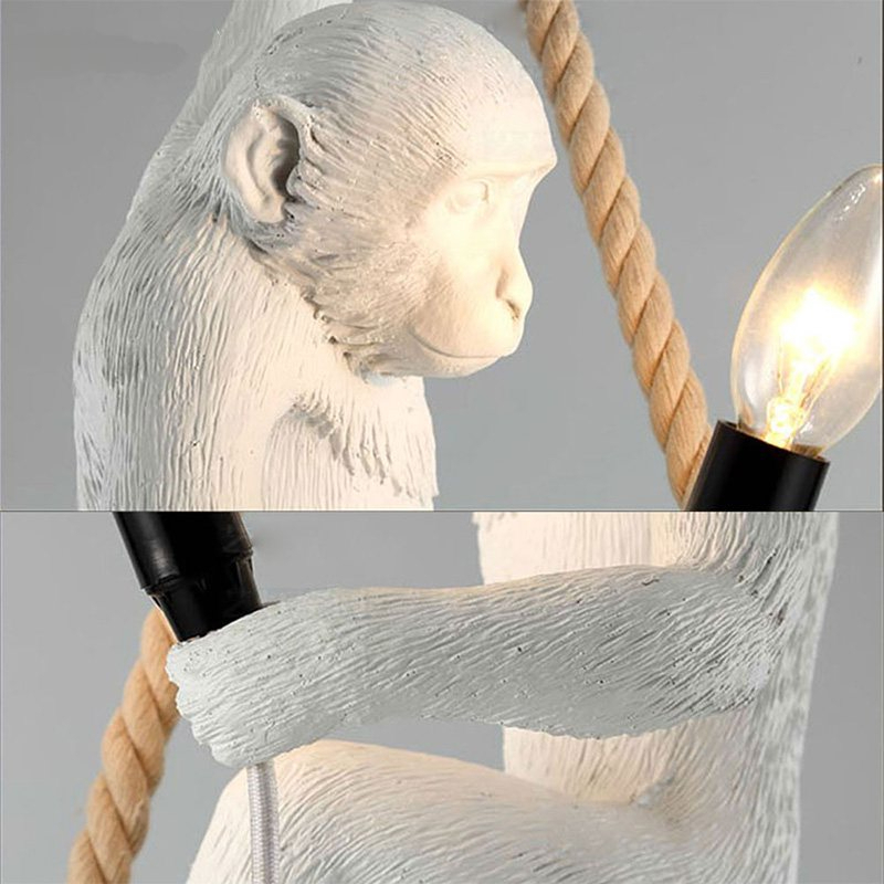 White monkey hanging from a rope presented in two opposing versions