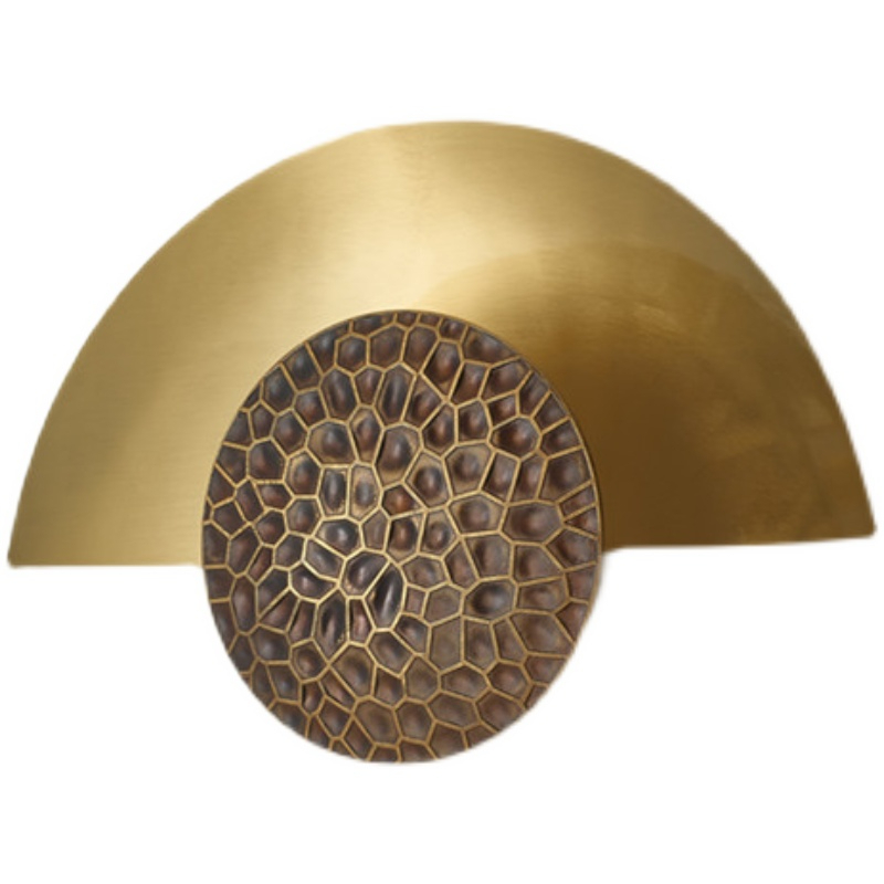 On a dark gray wall, a wall sconce hangs in the center in the shape of a lit golden half-moon.