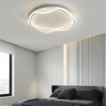 Modern white aluminium chandelier on grey background in a bedroom