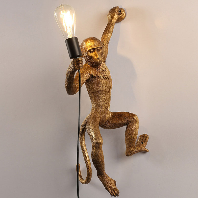 golden monkey wall light on a living room wall