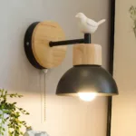 On one wall is a black Nordic-style wall sconce adorned with a white bird.