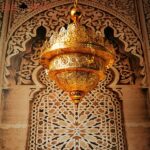 Oriental hanging lamp, openwork and carved with gold finish in an oriental decor