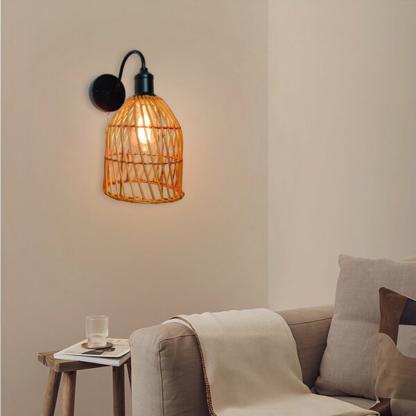 Rattan wall light with switch, with black stand, above a sofa