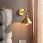 Retro design copper wall light, with yellow light, gold color wall light, in a room
