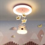 You can see a chandelier on the ceiling with a castle and crowns. Perfect for a girl's room.