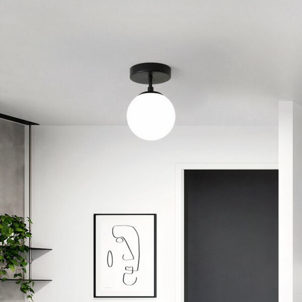 Round glass and iron LED bathroom ceiling light on grey background with picture