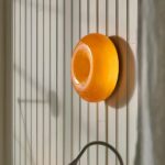 Round orange wall light, wall-mounted