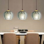 Smoked glass pendant with modern stripes in a dining room above a table