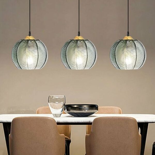 Smoked glass pendant with modern stripes in a dining room above a table