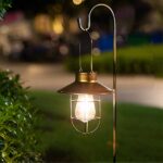 Solar-powered, retro outdoor LED light on a green background at night