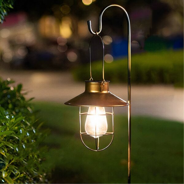 Solar-powered, retro outdoor LED light on a green background at night