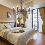 Retro adult bedroom chandelier in solid wood with beige background in a bedroom with a bed