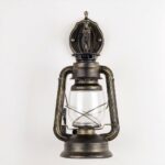 Vintage and industrial wall light in glass and metal on grey background
