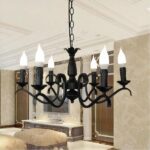 In the living room, a black wrought-iron chandelier hangs from the ceiling.