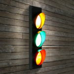 Vintage LED traffic light wall lamp on brown wood background