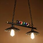 Vintage wrought iron billiard chandelier with orange background