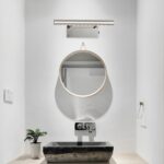 Waterproof bathroom wall light presented above an oval mirror