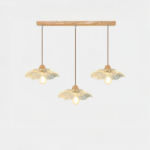 Chandelier with three pendants, a rectangular wooden base and glass pendants in the shape of a flower. On a white background.