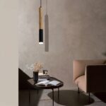 Black and beige LED wood tube pendant, hanging over a coffee table