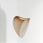 15318-0cBamboo chandelier suspended by two cables, composed of rings from the smallest to the largest, from left to right, linked by an LED strip. The result is an airy, conical shape. On a white background.
