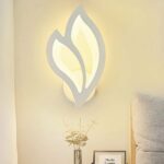 Decorative modern LED wall light in acrylic and iron on a white wall with a picture below
