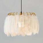 Crown-shaped feather chandelier, with gilded metal stems, suspended. On a gray background.